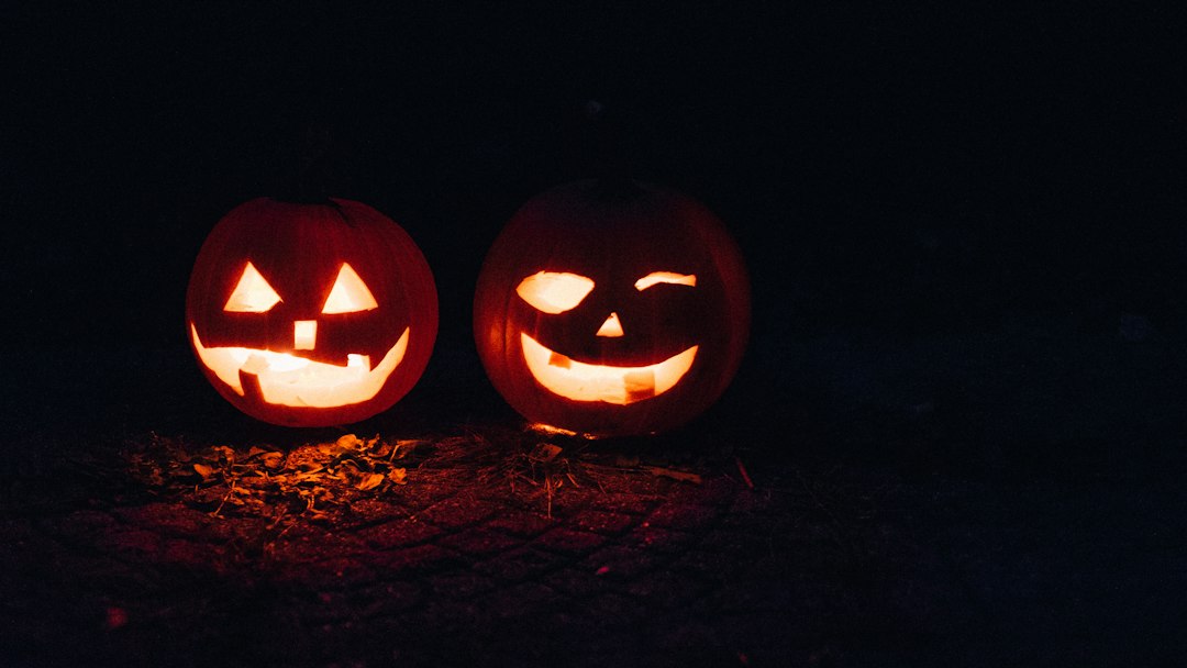 Carved Halloween pumpkin faces lined up at an adult party game night