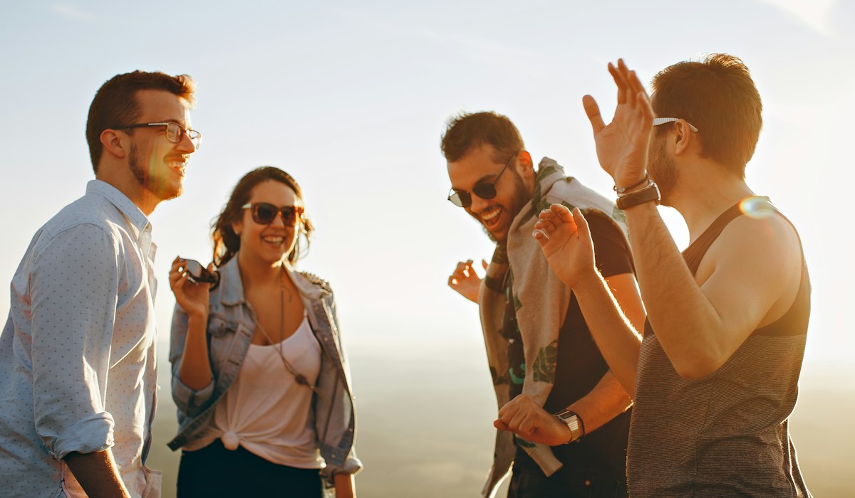 Friends laughing over clean dirty pick up lines to say to guys