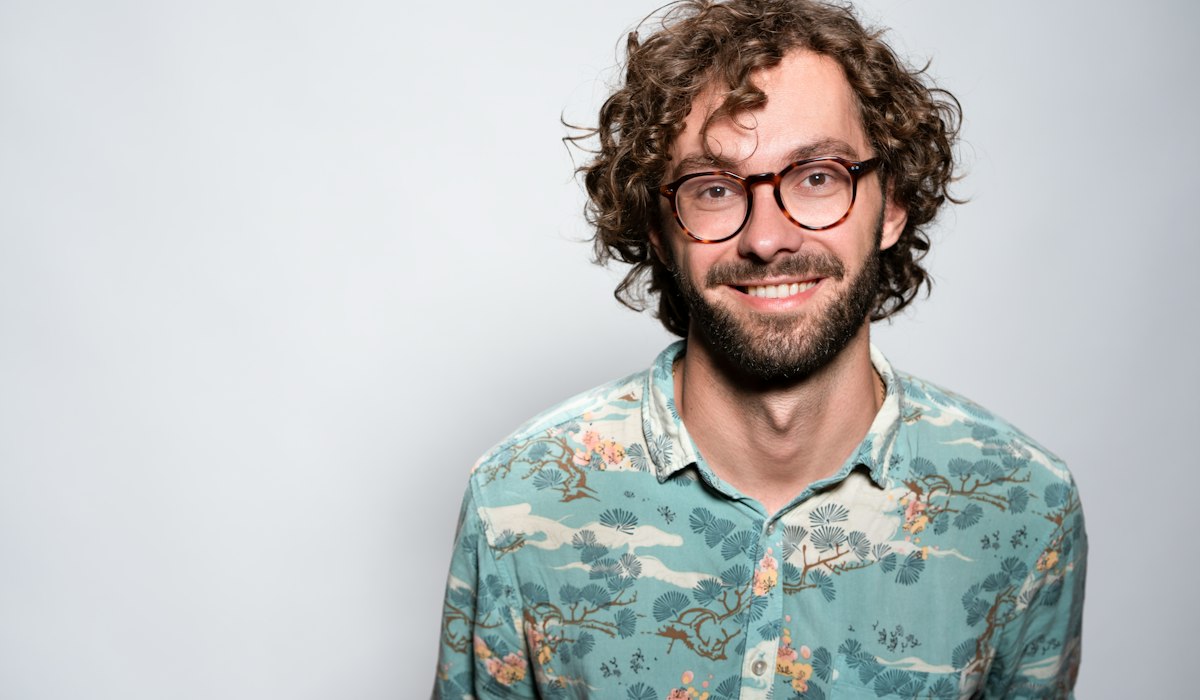 Man smiling shyly reacting to pick up lines to make him blush