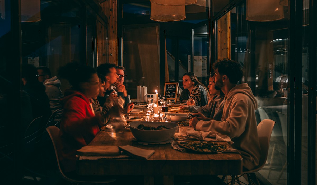 Zero prep Thanksgiving games for adults friends talking at table